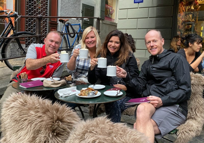 Two couples drinking hot chocolate at a restaurant table in Zurich, Switzerland