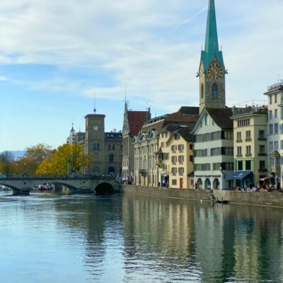 looking down the river in zurich switzerland with buildings on the side of the river