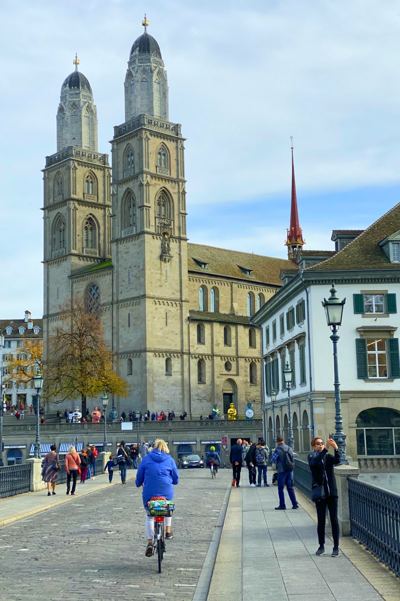 Zurich walking over bridge showing people riding bikes and taking photos