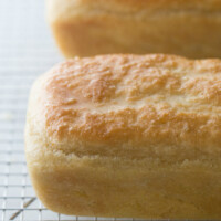 two loaves of english muffin bread cooling on a cooling rack