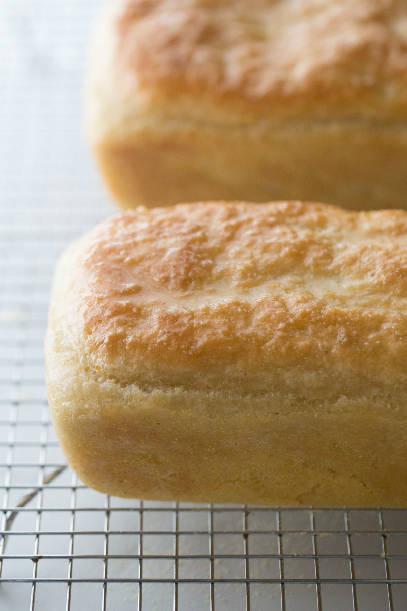 two loaves of english muffin bread cooling on a cooling rack