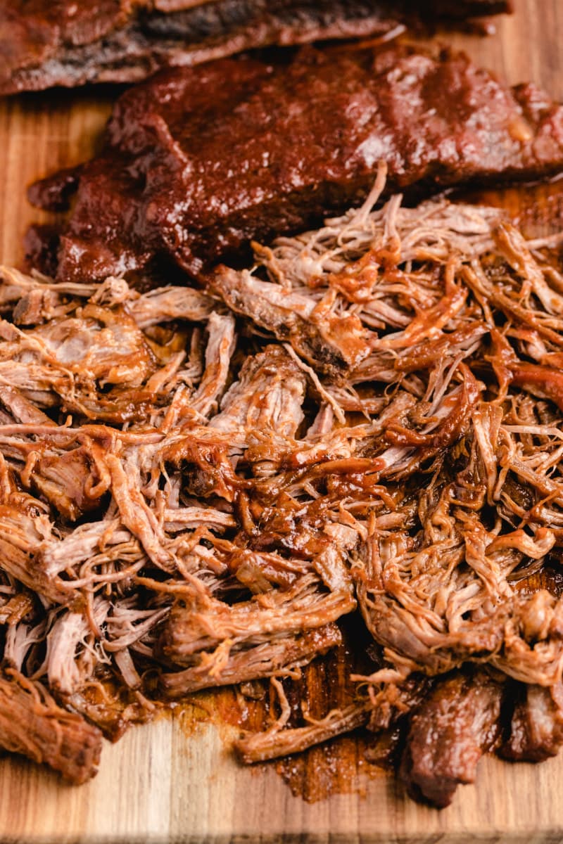 shredded barbecue beef on a cutting board