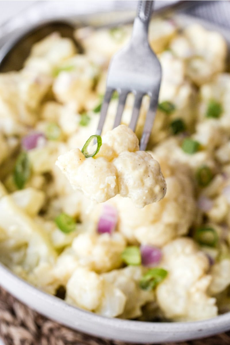 eating cauliflower potato salad with a fork