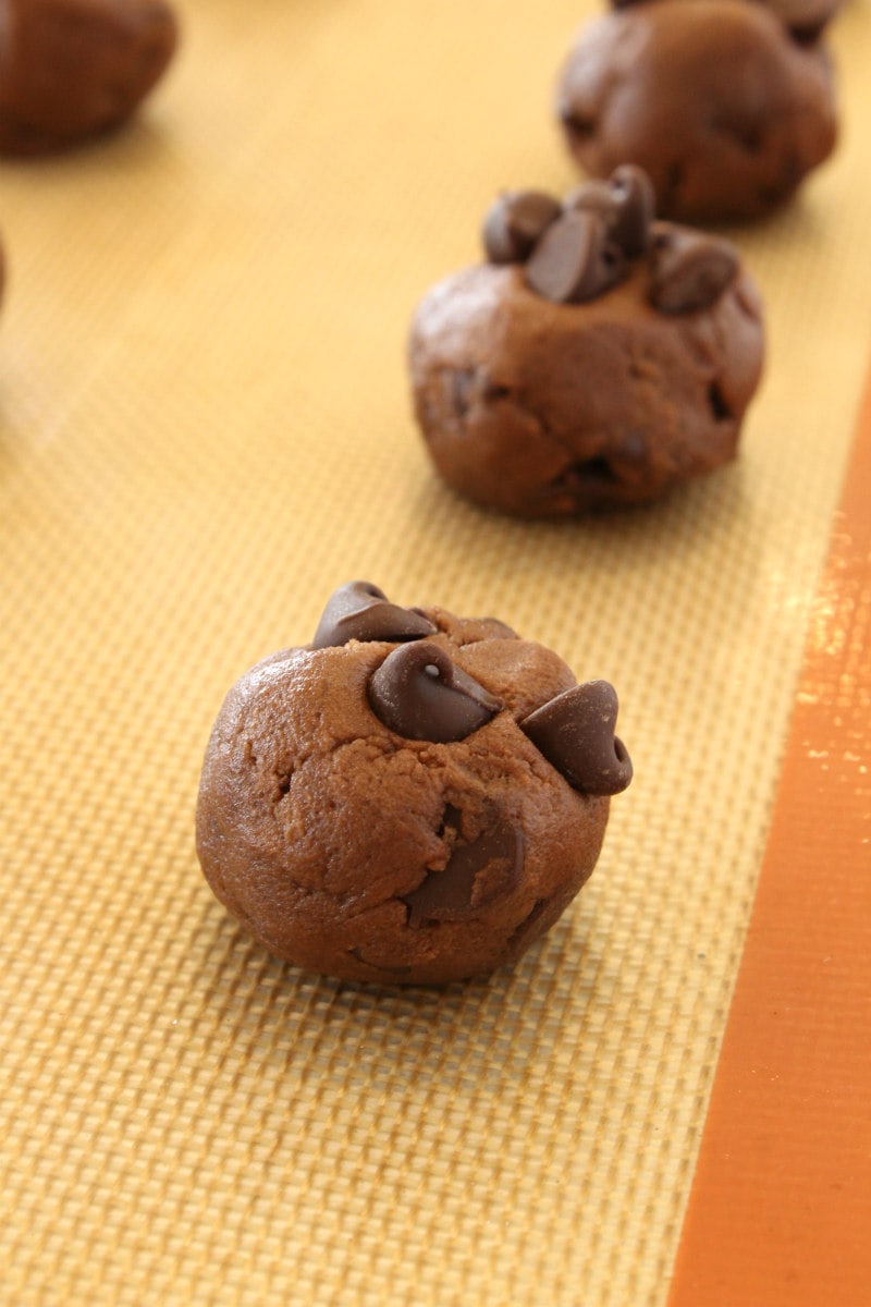 Chocolate chocolate chip cookie dough on a baking sheet ready for the oven