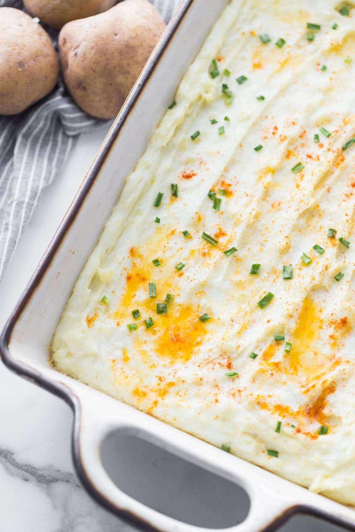 creamy oven baked mashed potatoes in baking dish