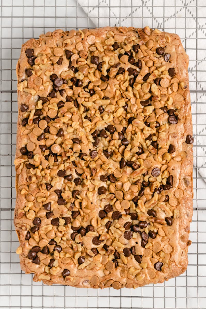 overhead shot of a pan of blondies with chocolate chips in one slab on a cooling rack