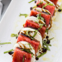 watermelon caprese salad on a white plate