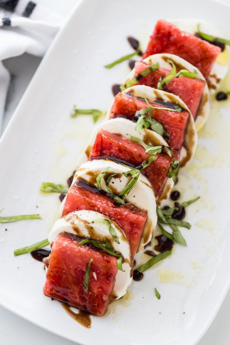 watermelon caprese salad on a white plate