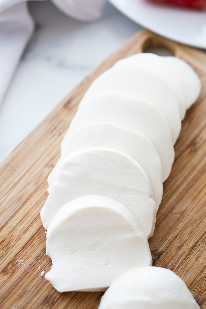 slices of fresh mozzarella on a cutting board