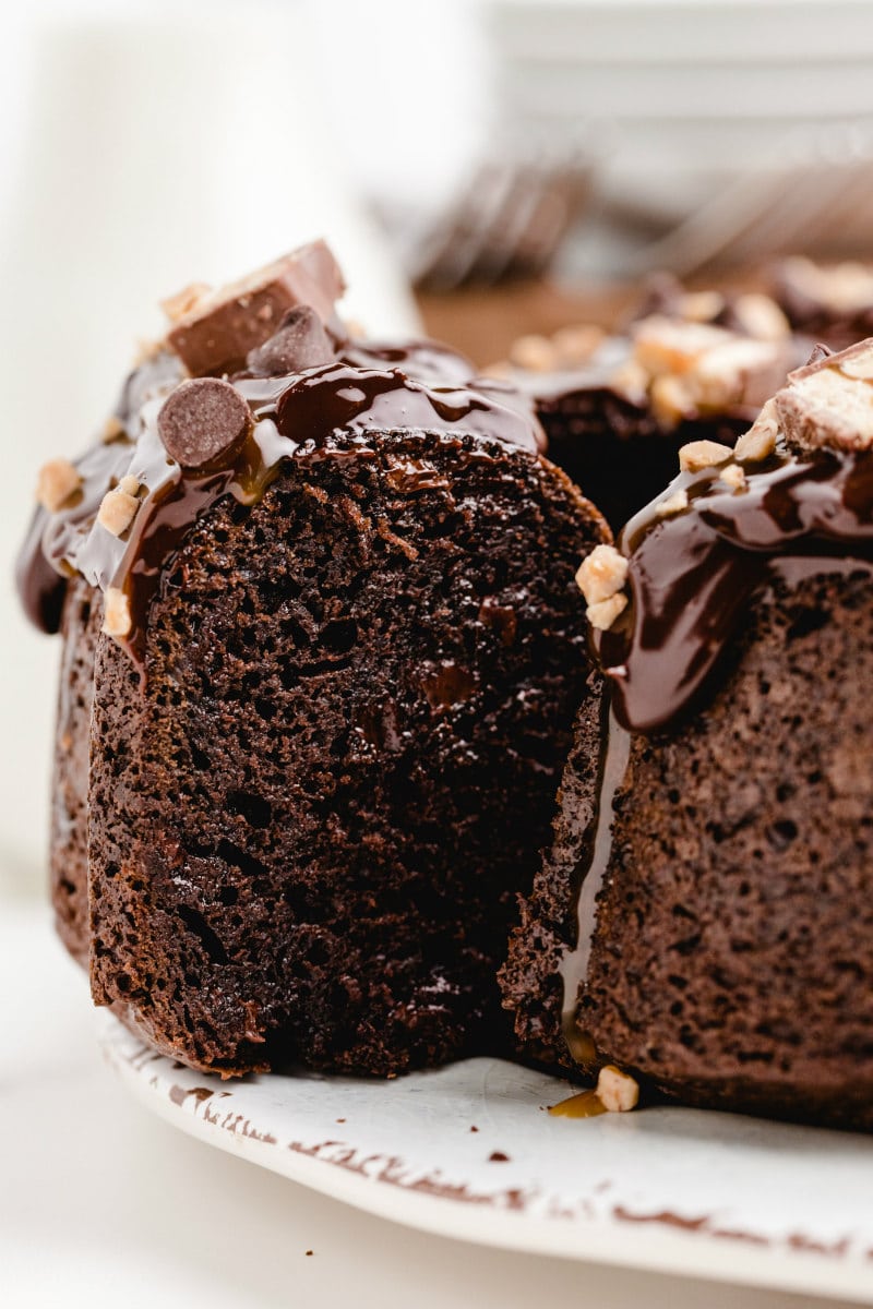 slicing chocolate wasted cake on a white platter