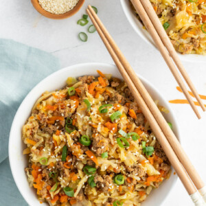 egg roll in a bowl with chopsticks on top