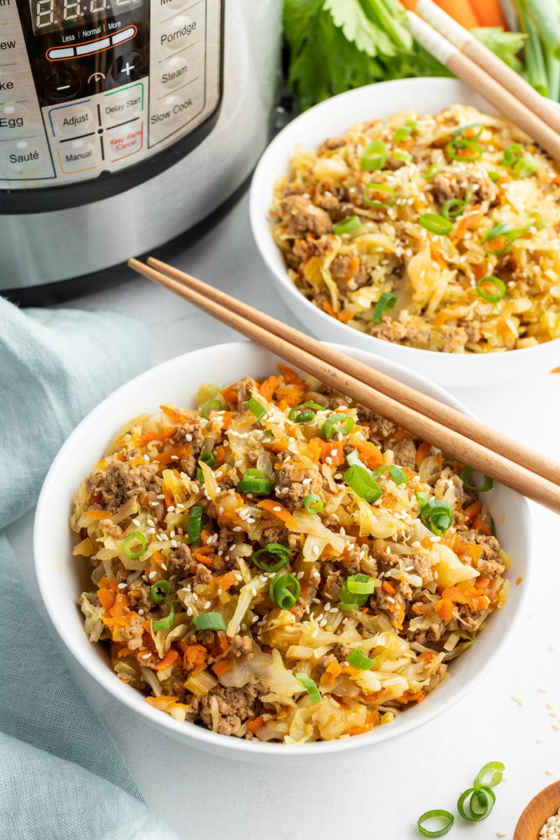 egg roll in a bowl with chopsticks sitting on top