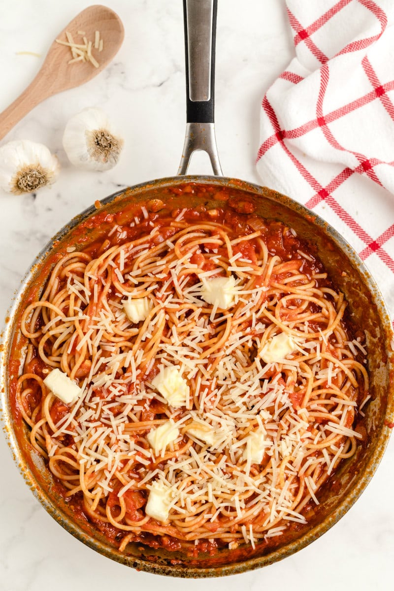 pasta pomodoro in a pan with butter and parmesan