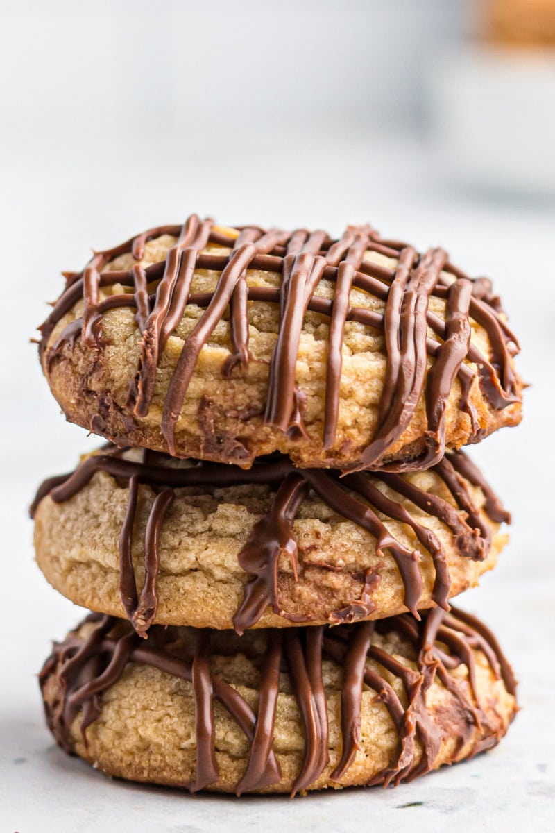 close up stack of three chocolate covered peanut butter cookies
