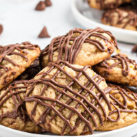 chocolate drizzled peanut butter cookies on white platter