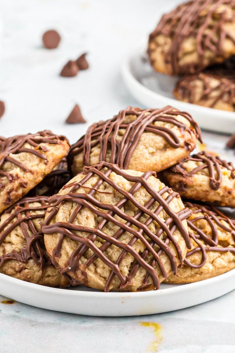 chocolate drizzled peanut butter cookies on white platter