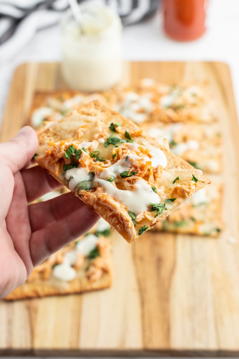 hand holding a piece of flatbread