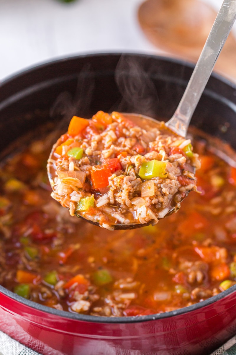 ladling out soup from pot