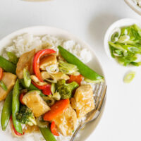 stir fry on a white plate with rice