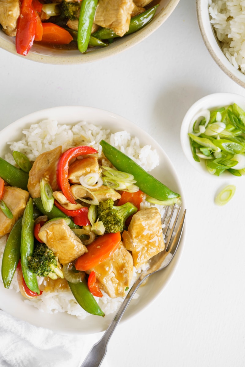 stir fry on a white plate with rice