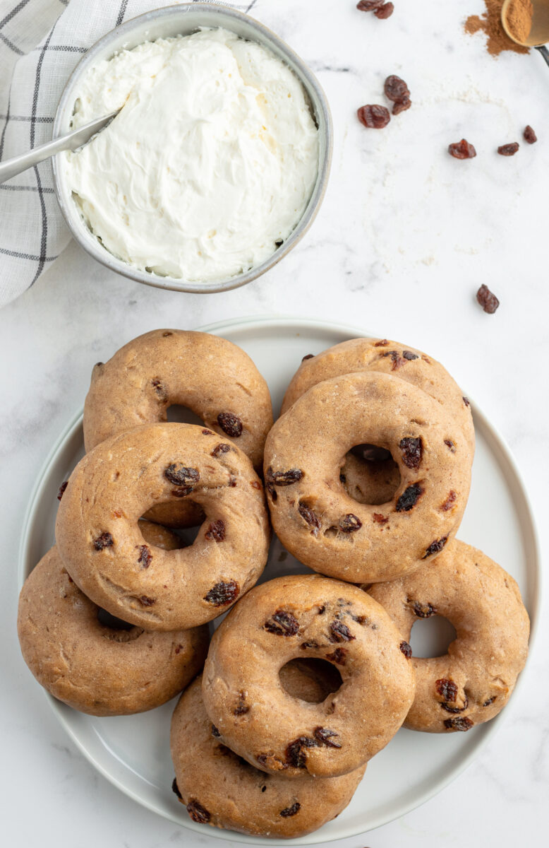 2 ingredient cinnamon raisin bagels on a plate with bowl of cream cheese
