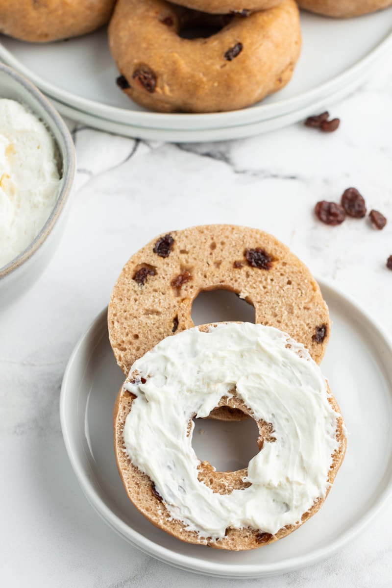 cinnamon raisin bagel cut in half with cream cheese