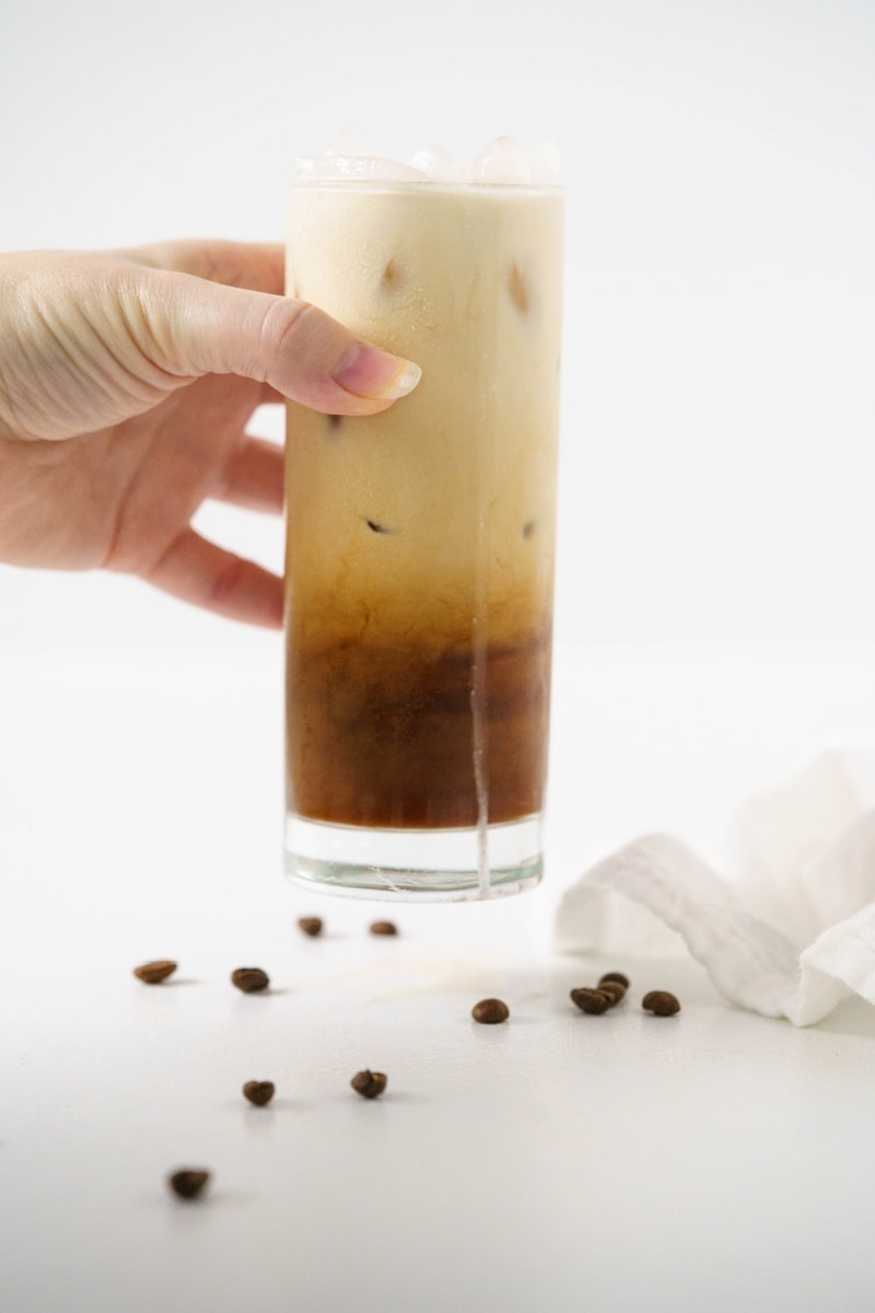 hand holding iced vanilla latte