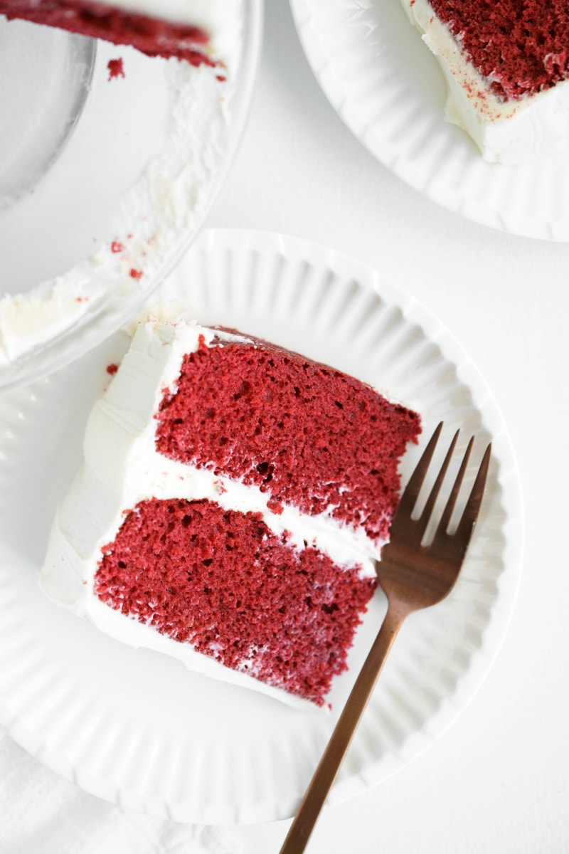 slice of red velvet cake on plate with fork