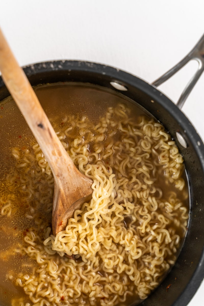 ramen cooking in broth in a pan