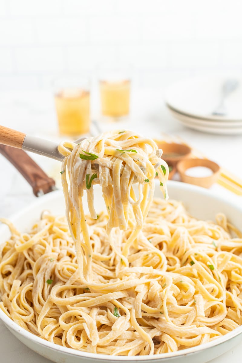 forkful of fettucine alfredo over dish