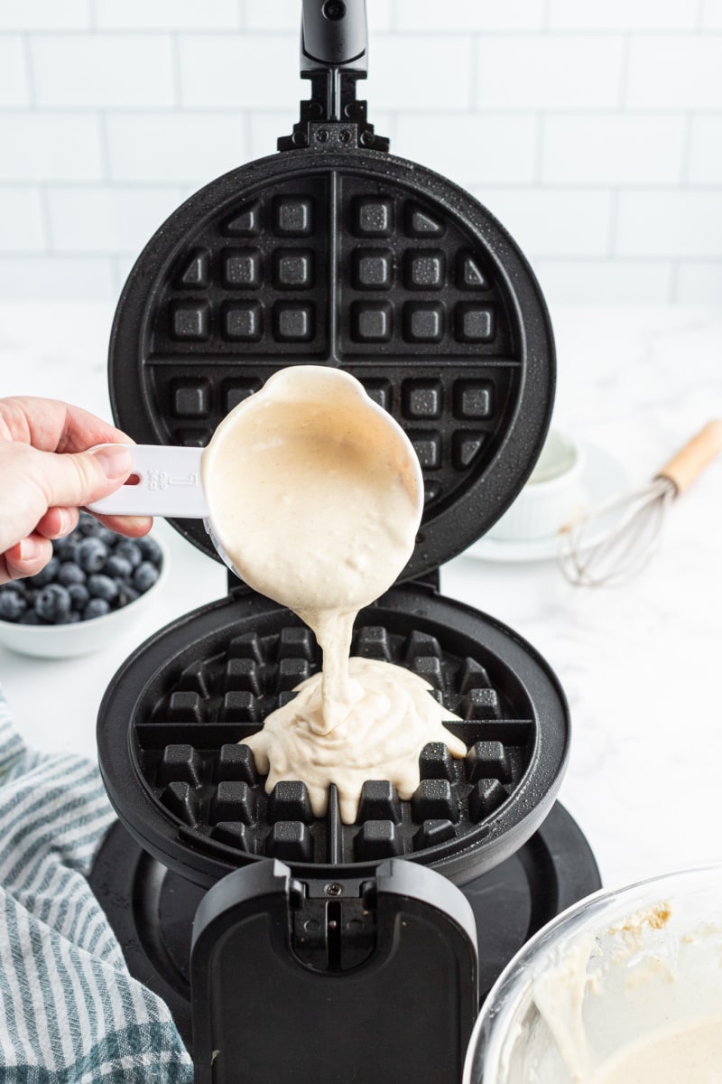 batter being poured into waffle iron