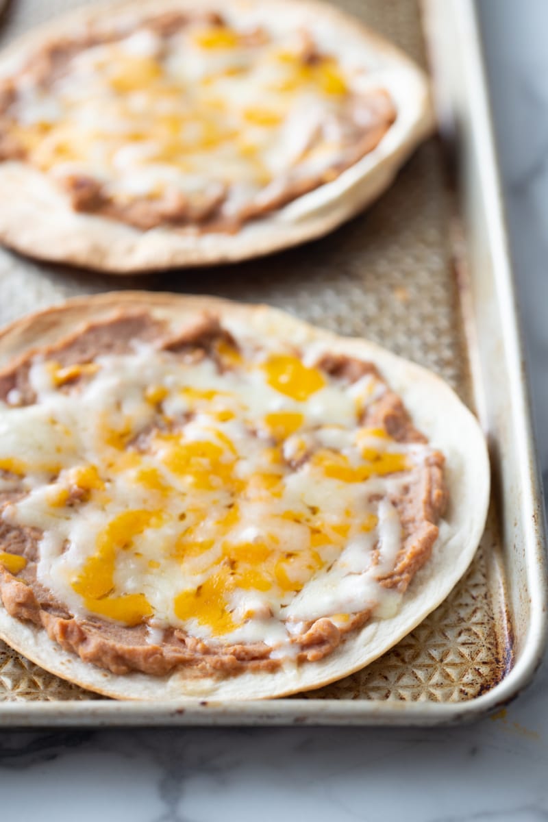 tortillas toasted with beans and cheese