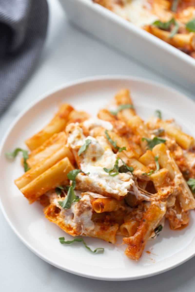 serving of burrata baked ziti on white plate