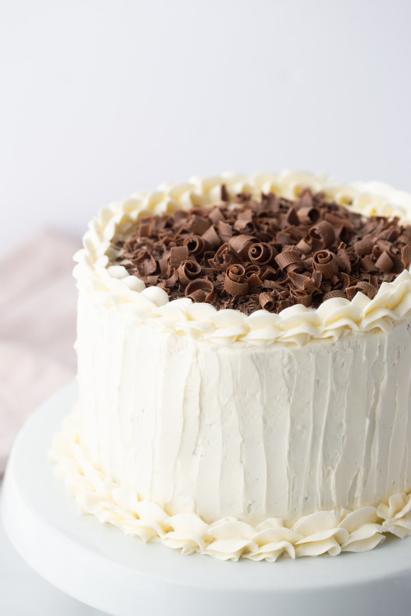 wedding cake with white frosting and chocolate shavings on top