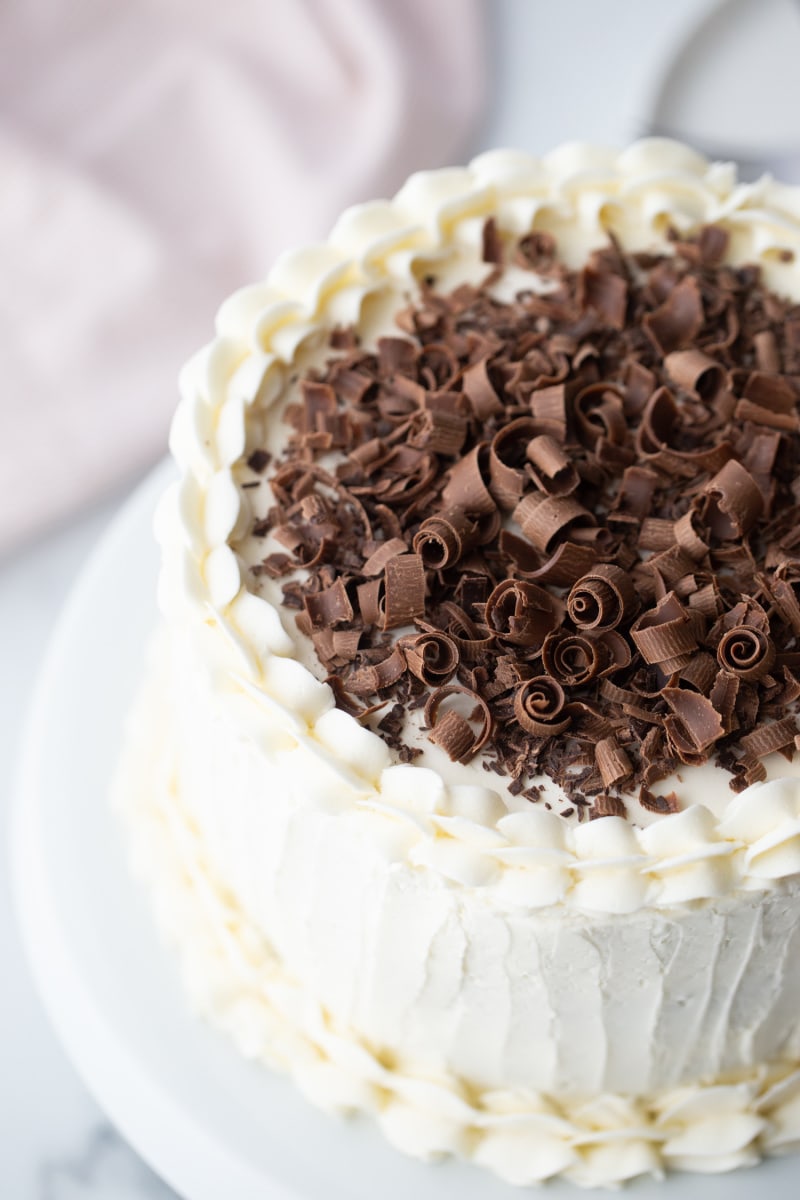 white wedding cake with chocolate shavings on top