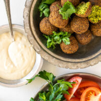 falafel in bowl and tahini sauce and fresh veggies
