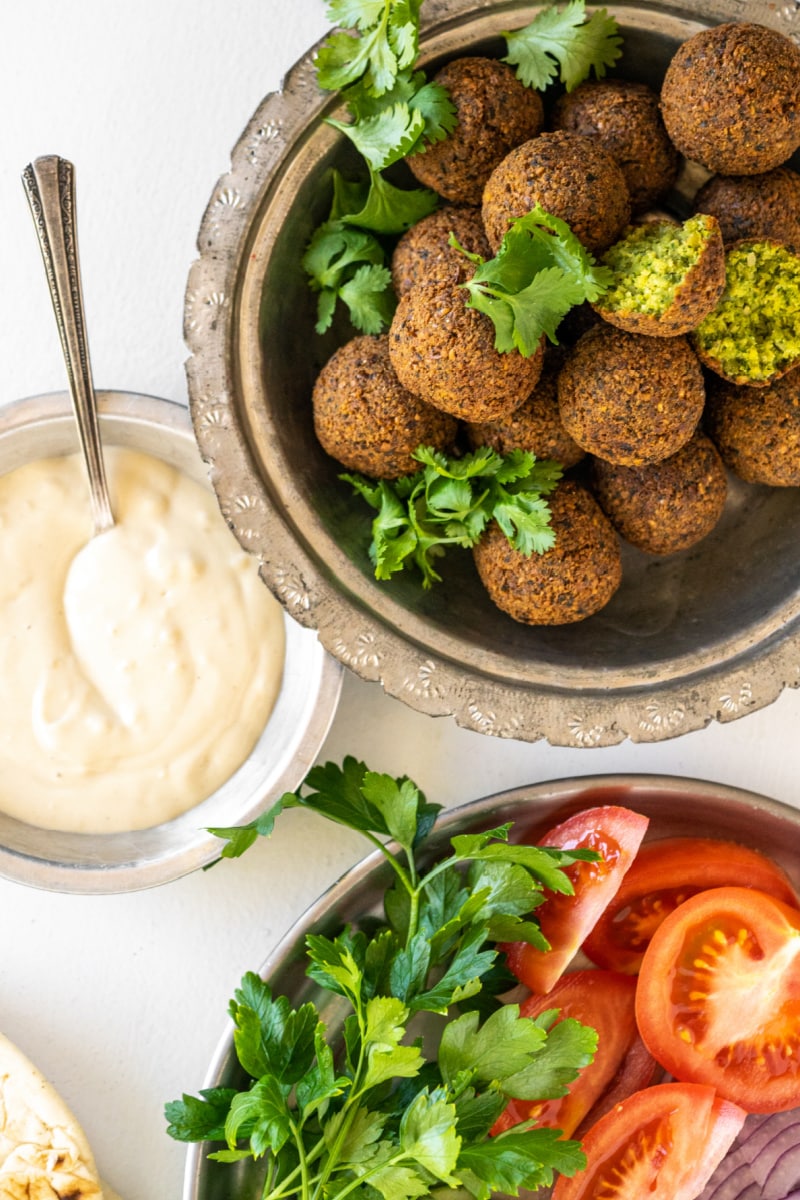 falafel in bowl and tahini sauce and fresh veggies