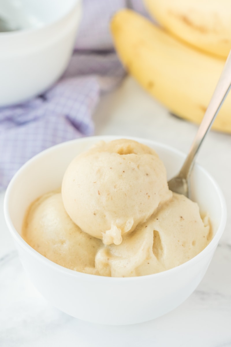 scoops of banana ice cream in a white dish