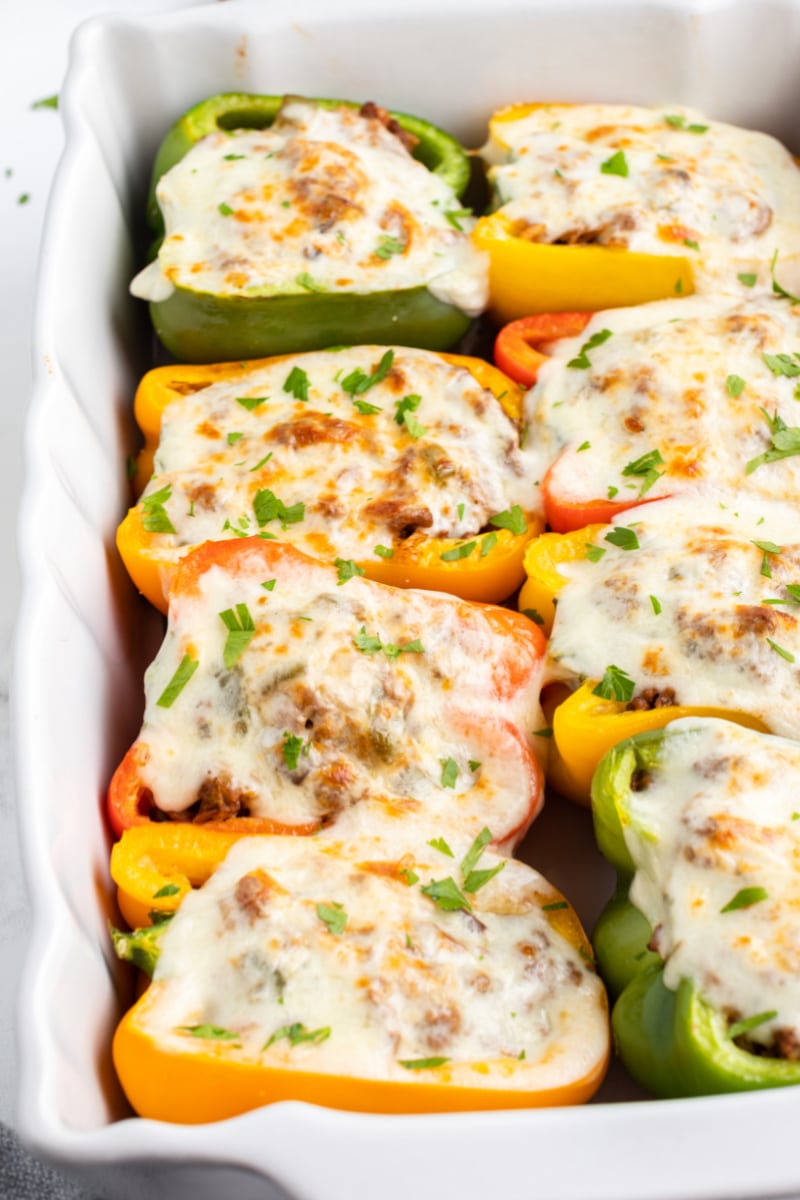 philly cheesesteak stuffed peppers in a white casserole dish