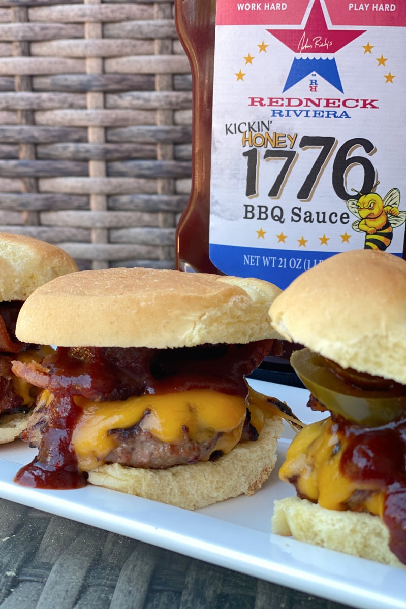 Cowboy Sliders recipe from RecipeGirl.com #cowboy #sliders #recipe #RecipeGirl cowboy sliders on a plate with barbecue sauce