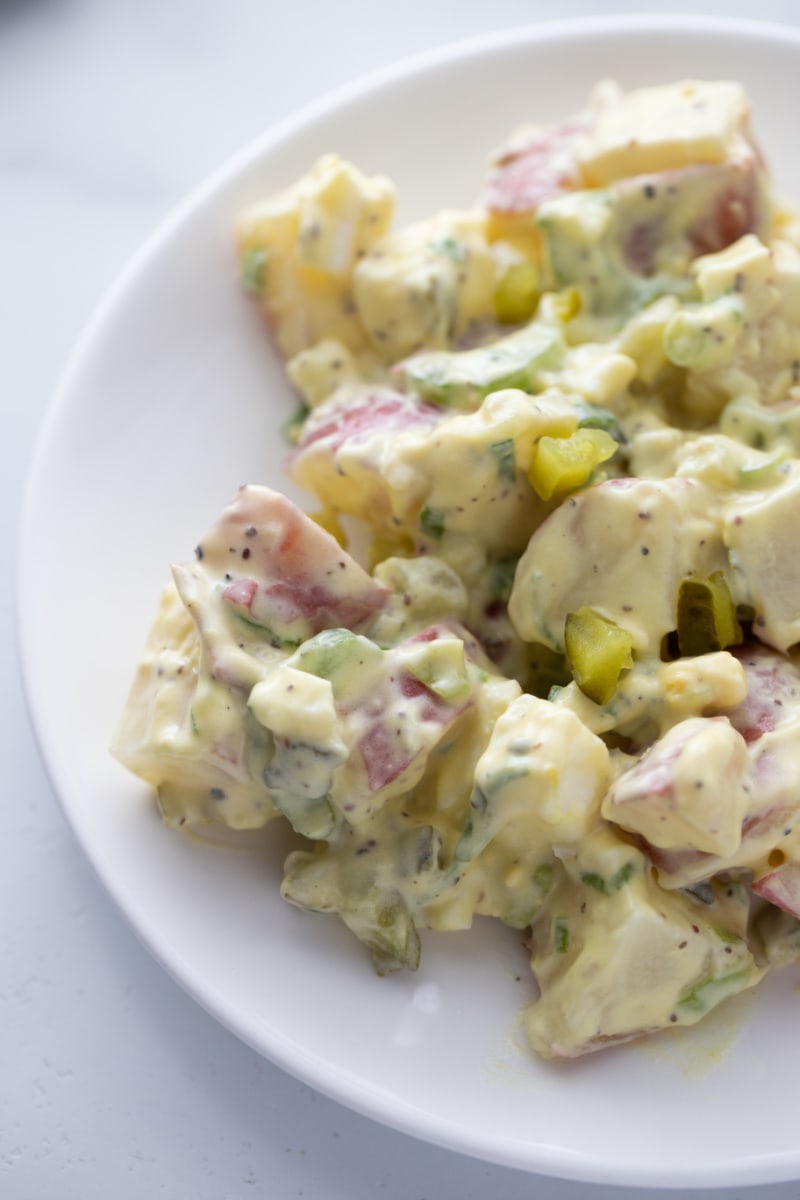 serving of potato salad on white plate
