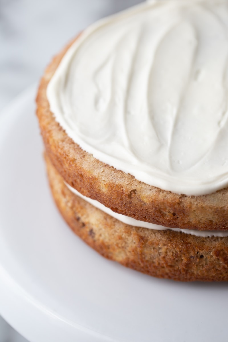 two layers of hummingbird cake with white frosting on top