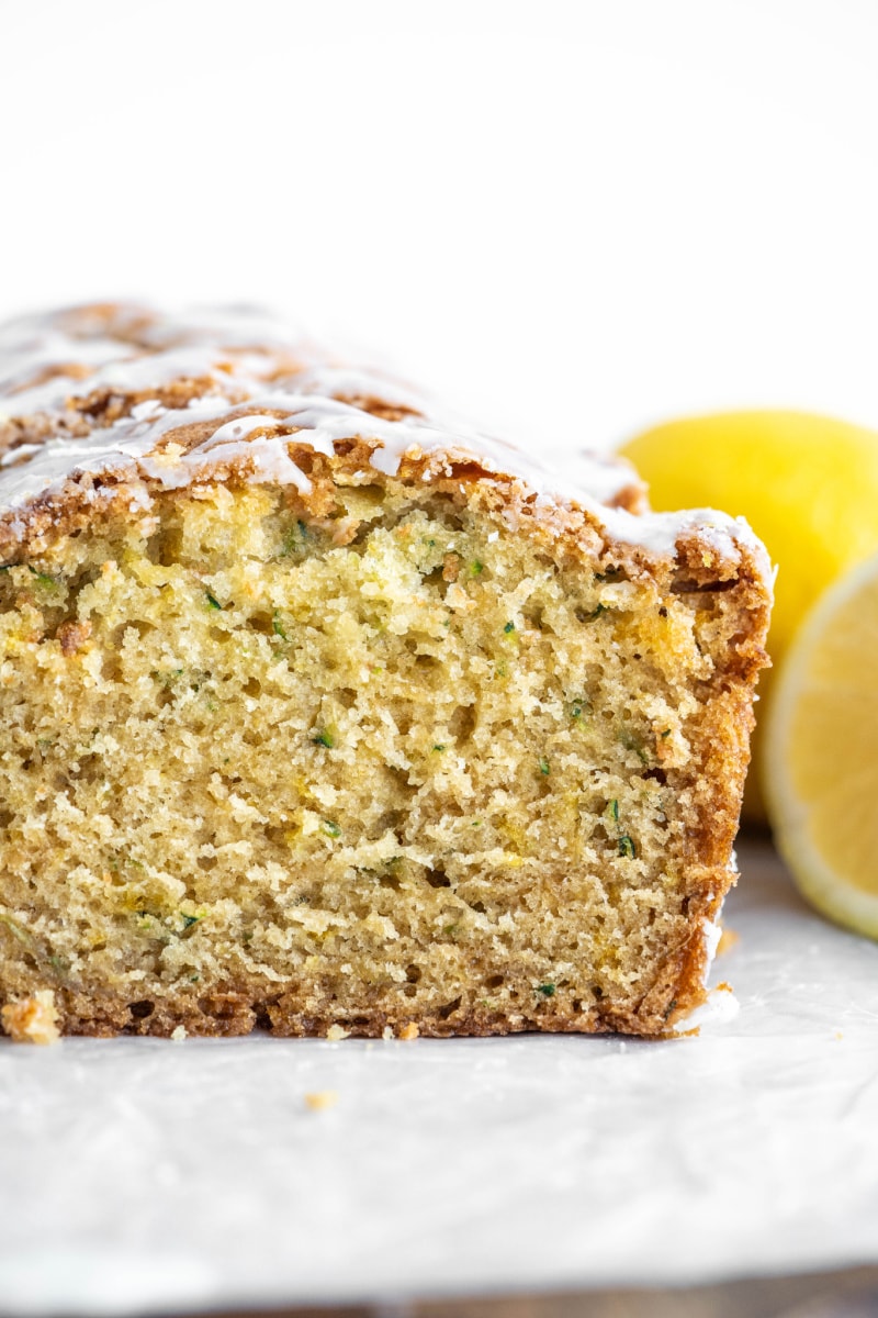 iced lemon zucchini bread sliced open to see inside