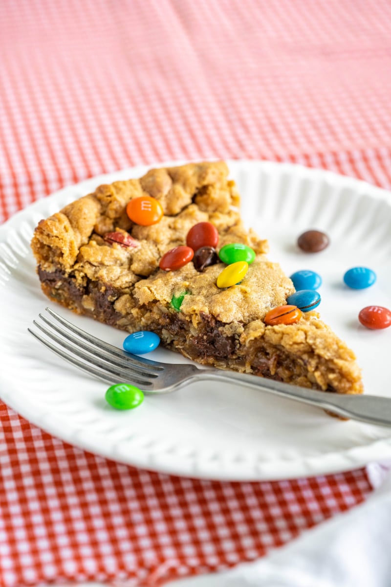 slice of monster skillet cookie on paper plate