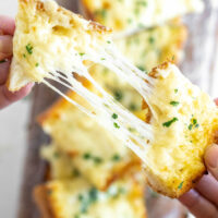 pulling cheesy garlic bread apart