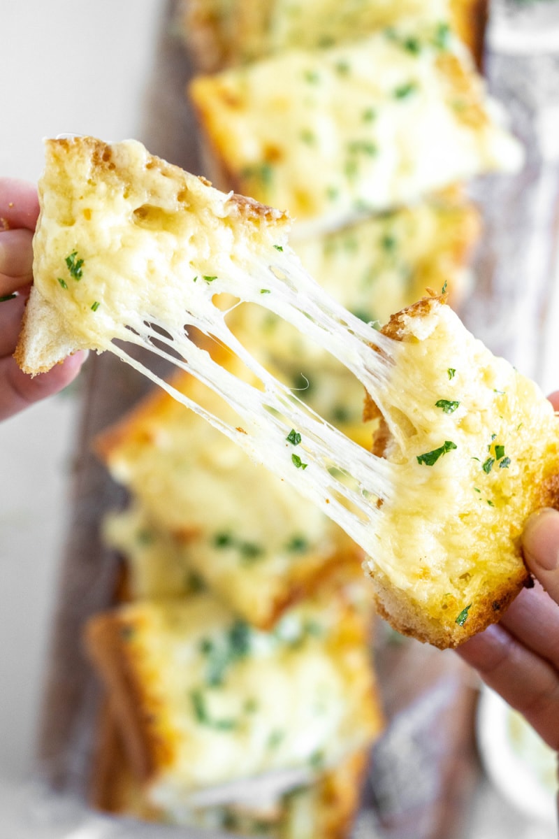 pulling cheesy garlic bread apart