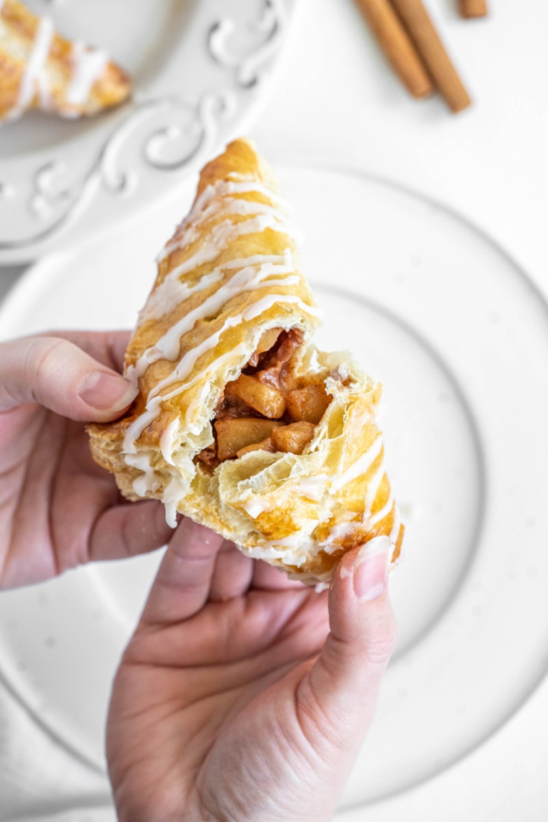 hands pulling apart an apple turnover