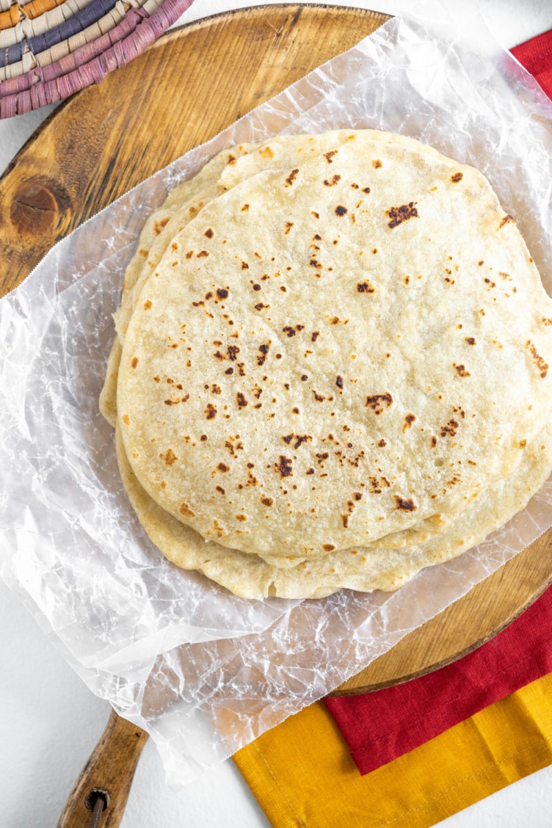 flour tortillas in a stack on a board