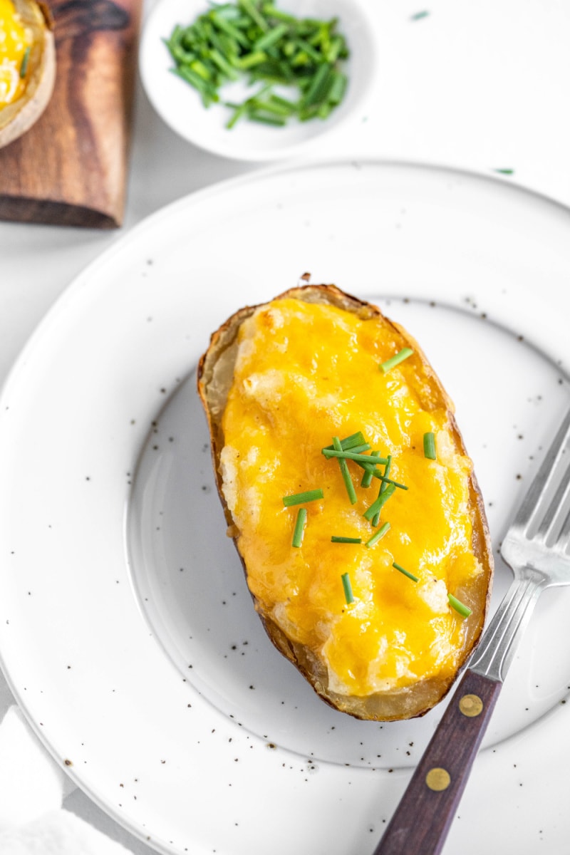 one serving of twice baked potato on white plate