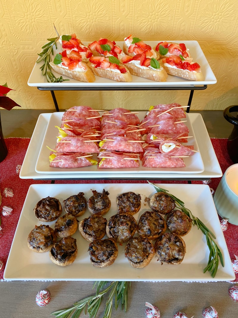 three tiered tray with appetizers displayedd